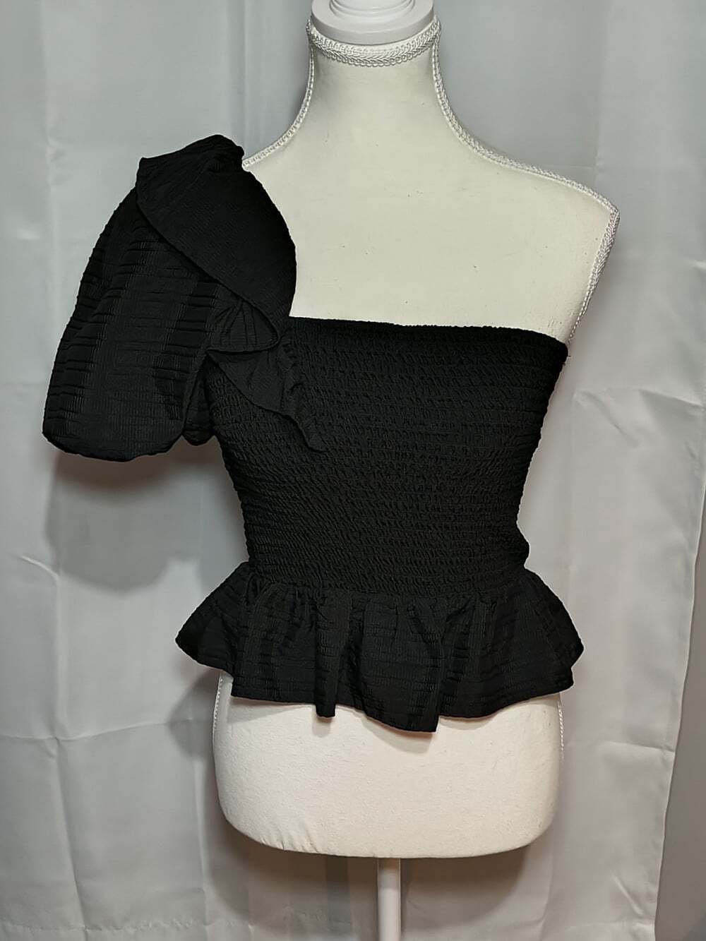 black smocked one-shoulder top with a puff sleeve and a cropped peplum fit Small